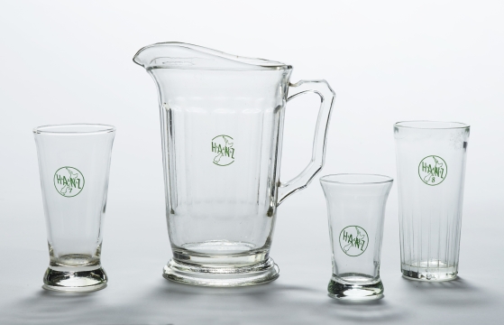 Glassware, mid-1960s, by Crown Crystal Glass, New Zealand (GH021024-25, GH023164, GH024221, Te Papa) Standardised glassware was introduced by the Hotel Association of New Zealand (HANZ) in 1963.  The 8 ounce glass on the far right was favoured by male drinkers.  The smaller 7 ounce glass on the left and the small sherry glass were favoured by women drinkers.  Jugs were considered an innovation in the early 1960s. 